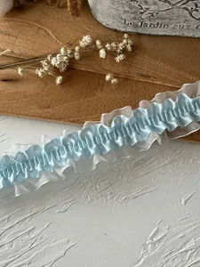 Detail of light blue pleated lace trim with satin and organza for DIY garment sewing