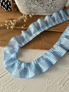 Close-up of blue gingham pleated lace trim for DIY dress sewing and home decoration