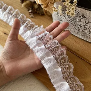 White ruffled lace trim with satin ribbon detail for DIY sewing and doll clothing crafts