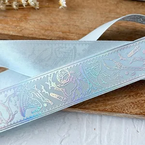 Light blue magical ribbon with iridescent holographic wizard hats and stars for DIY crafting