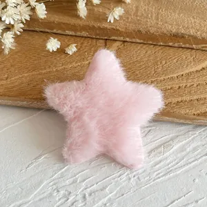 Detailed close-up of a soft pink plush star-shaped DIY craft accessory on a stone surface