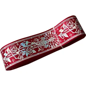 Red ribbon roll with metallic silver rose pattern for DIY crafts and gift wrapping