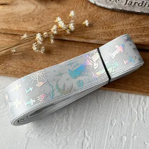 Detail of gray ribbon with laser-printed cross and spider web Gothic patterns