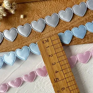 Embroidered heart lace trim in silver, blue, and pink for DIY sewing and craft projects