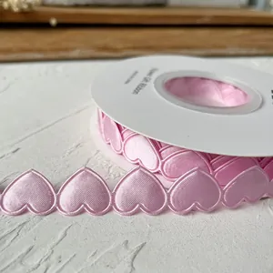 Pink heart-shaped satin ribbon roll for gift wrapping and DIY crafts decoration
