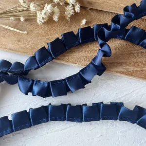 Dark blue pleated satin ribbon trim with elegant ruffled folds for DIY sewing and crafts