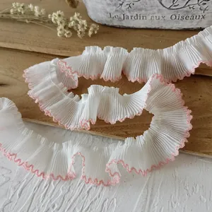 French pleated chiffon lace trim with white fabric and pink scalloped edge detail