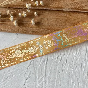 Close-up of laser-printed laser ginger ribbon with crown and snake motif for DIY