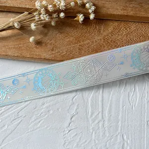 Close-up of holographic gradient ribbon with geometric star patterns for DIY crafts