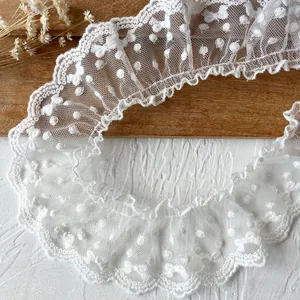 White lace trim with polka dot embroidery and scalloped edges for DIY sewing projects