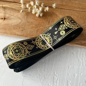 Black ribbon with gold celestial patterns featuring stars and moons for DIY crafts