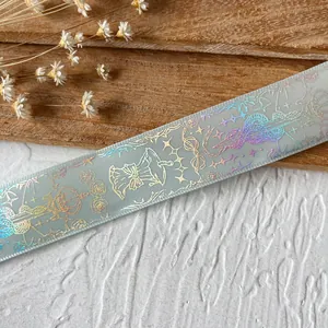Detailed holographic laser patterns with butterfly bows on light blue decorative ribbon