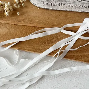 5-meter heavy-duty white elastic band for sewing and DIY crafts shown on rustic wood surface