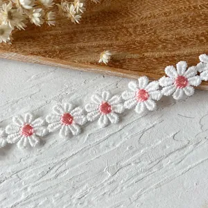 Detail shot of white and pink daisy embroidery lace ribbon for DIY sewing projects