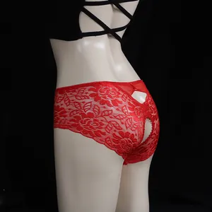 Sexy red lace open-crotch panties with floral embroidery and bow detail on a mannequin