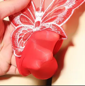 Detail of red mesh thong featuring intricate red and white butterfly embroidery craftsmanship