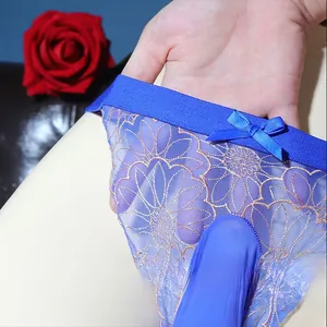 Detail of men's sexy sheer mesh G-string with floral embroidery and bow knot