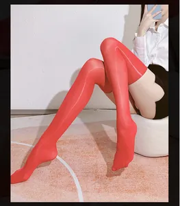 Detailed view of red high-gloss thigh-high stockings with smooth reflective finish