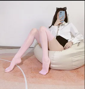 Detail view of pink glossy thigh high stockings with shiny smooth reflective texture