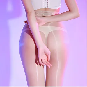 Close-up of glossy skin-tone pantyhose with lace high waist and silky oil shine finish