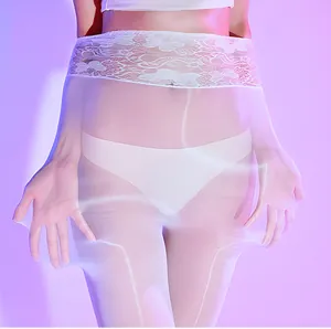 Detailed view of high waist floral lace waistband on ultra-thin white sheer tights