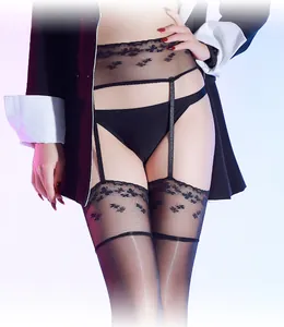 Detail of floral lace trim and adjustable garters on sheer black oil-gloss stockings