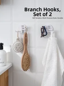 Detail of white 180-degree rotating wall hooks set showing multi-functional usage in bathroom