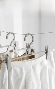 Detail of grey non-slip pants hanger with adjustable clips and windproof hook feature