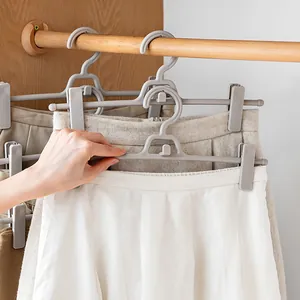 Space-saving stackable grey plastic pants hanger with adjustable non-slip clips for closet