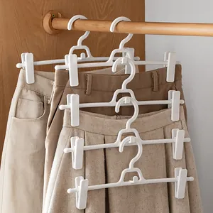 Space-saving white plastic pants hanger with adjustable clips and stackable hook design