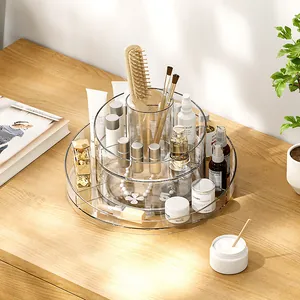 Rotating 2-tier transparent acrylic makeup organizer on wooden desk for skincare storage