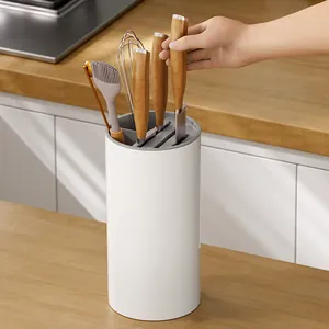Multifunctional white kitchen knife holder with gray slots on a countertop