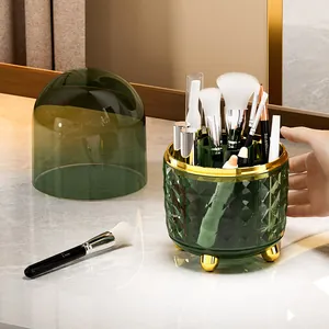 Rotating dark green acrylic makeup brush holder with gold legs and dustproof lid