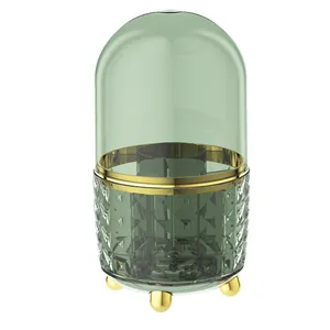 Rotating emerald green makeup brush holder with transparent dustproof lid and gold accents