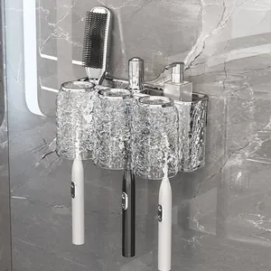 Wall-mounted bathroom organizer with three wave-pattern glass cups and metal toothbrush rack