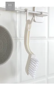 Detail of ergonomic white cleaning brush featuring a convenient hanging hole for storage