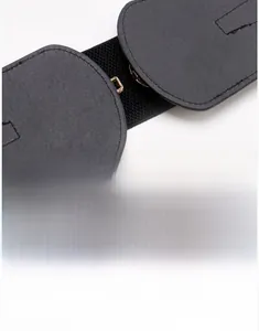 Detailed close-up of high-elasticity black waist belt with golden metal fastener