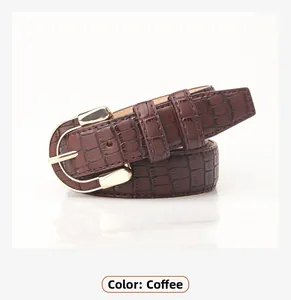 Detail of coffee brown PU leather belt with crocodile texture and gold alloy buckle