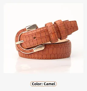 Close-up of camel embossed crocodile pattern PU leather belt with golden D-ring buckle