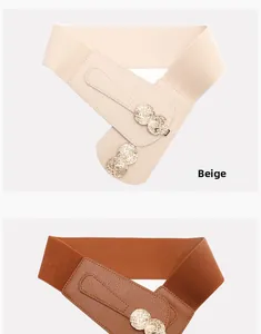 Detail of elastic waist belts in beige and brown with vintage gold embossed buckles