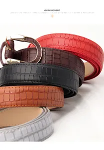 Detail view of colorful faux crocodile leather belts with gold metal D-ring buckles