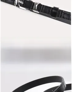 Detail of silver alloy pin buckle with black faux crocodile leather embossed texture belt