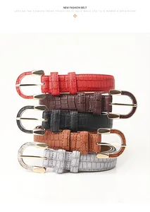 Detail of five vintage crocodile pattern PU leather belts with gold U-shaped metal buckles