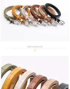 Detail of high-quality faux leather belts with stone pattern and silver pin buckles