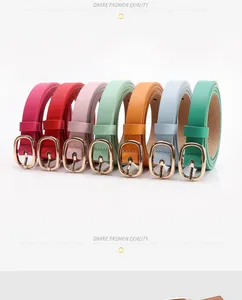 Macro shot of colorful slim belts with golden oval buckles for women's fashion outfits