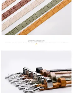 Close-up of crocodile texture leather belts with polished silver buckles in various colors