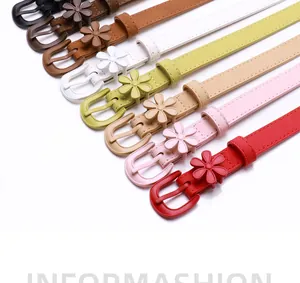 Flat lay of thin leather flower belts in eight colors including black brown and pastel shades