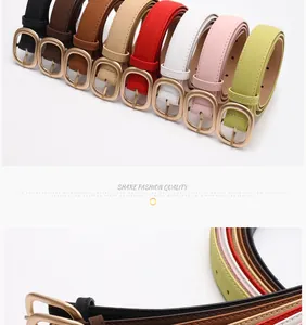 Detail of minimalist women's belts with matte gold oval buckles in eight various colors
