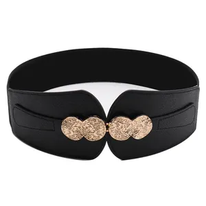 Women's black elastic corset belt with vintage hammered gold metal buckle on white background