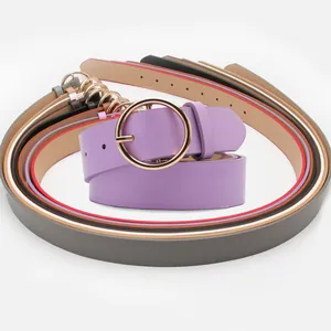 Women's minimalist faux leather belts set with round gold buckles in multiple colors